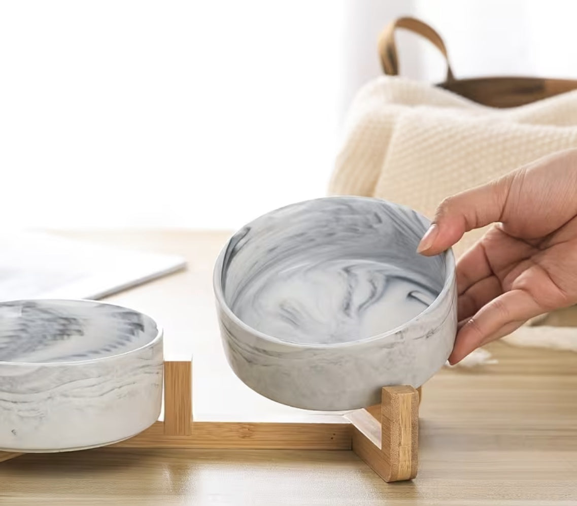 Marble ceramic pet bowl close-up showing swirl finish and bamboo rack